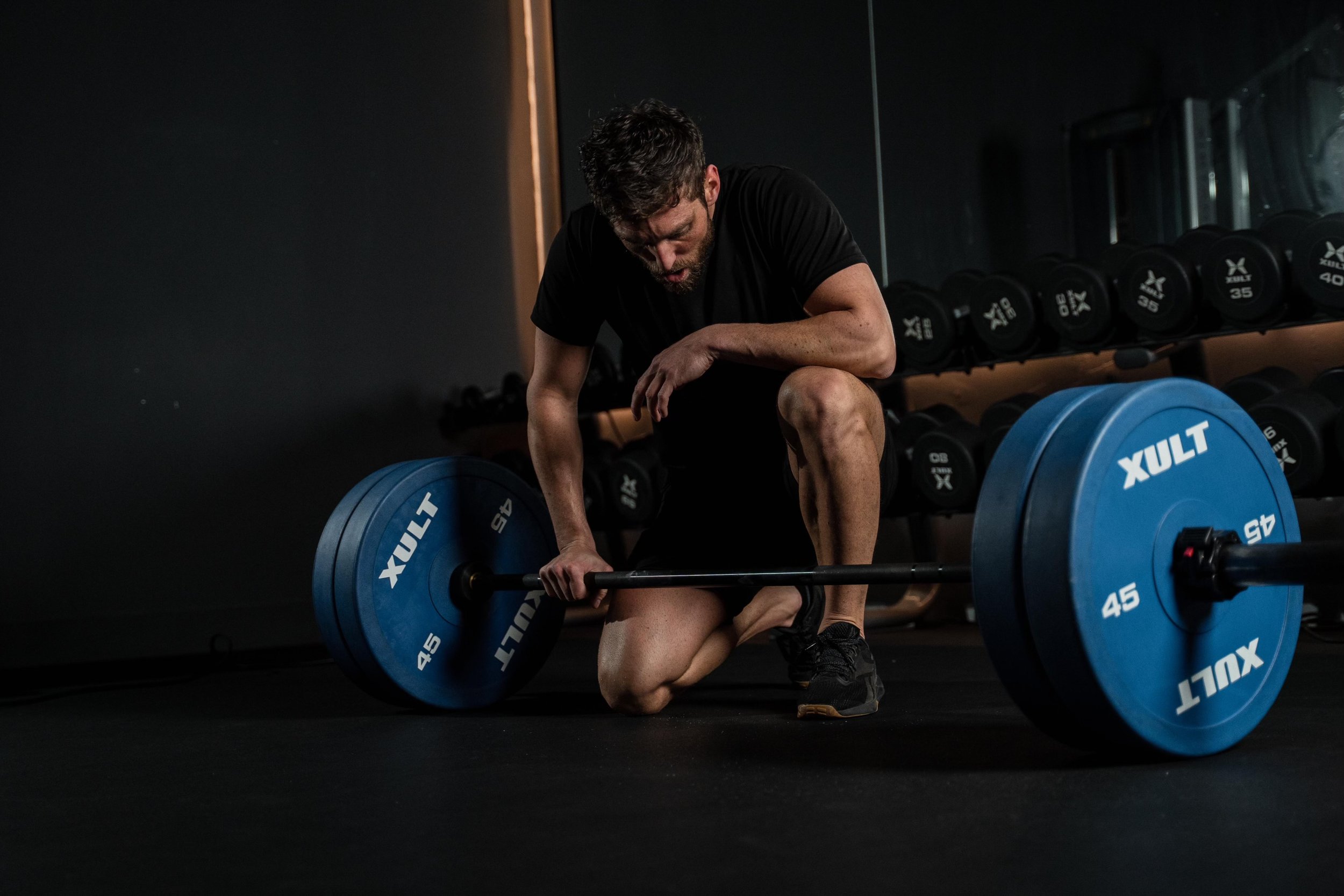 Adrien Maggione coaching a client on the deadlift at Maggione Fit